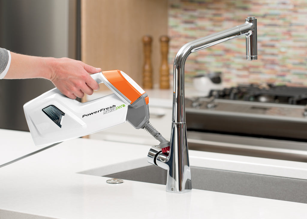 Powerfresh Pet Lift-Off Steam Mop Using Hand Steamer
                        on Kitchen Sink. 