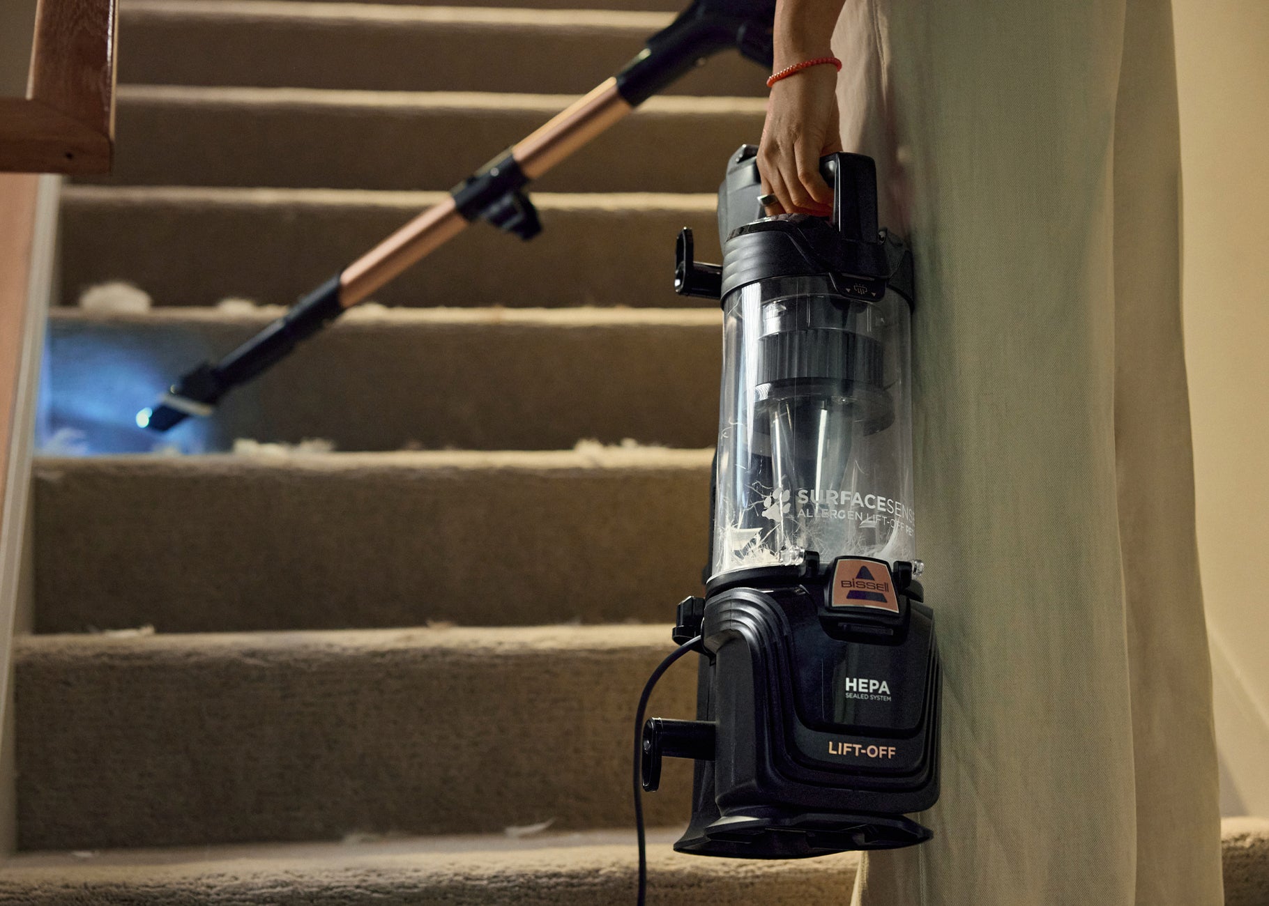 Using Lift Off Pod with extension wand and crevice tool to vacuum stairs