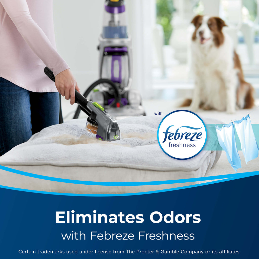 Using Hose of upright carpet cleaner with attachment
                        on pet bed with dog nearby. Text: Eliminates Odors with Febreze Freshness