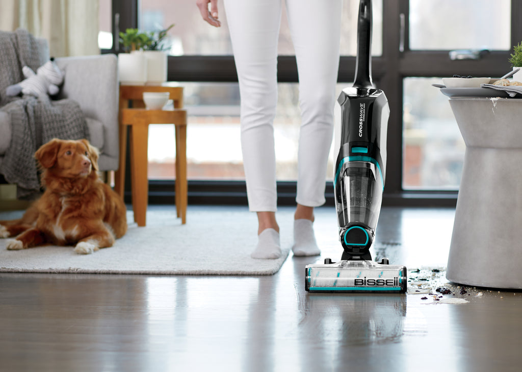 CrossWave Cordless Max vacuuming and mopping spilled
                        mess on hard flooring.