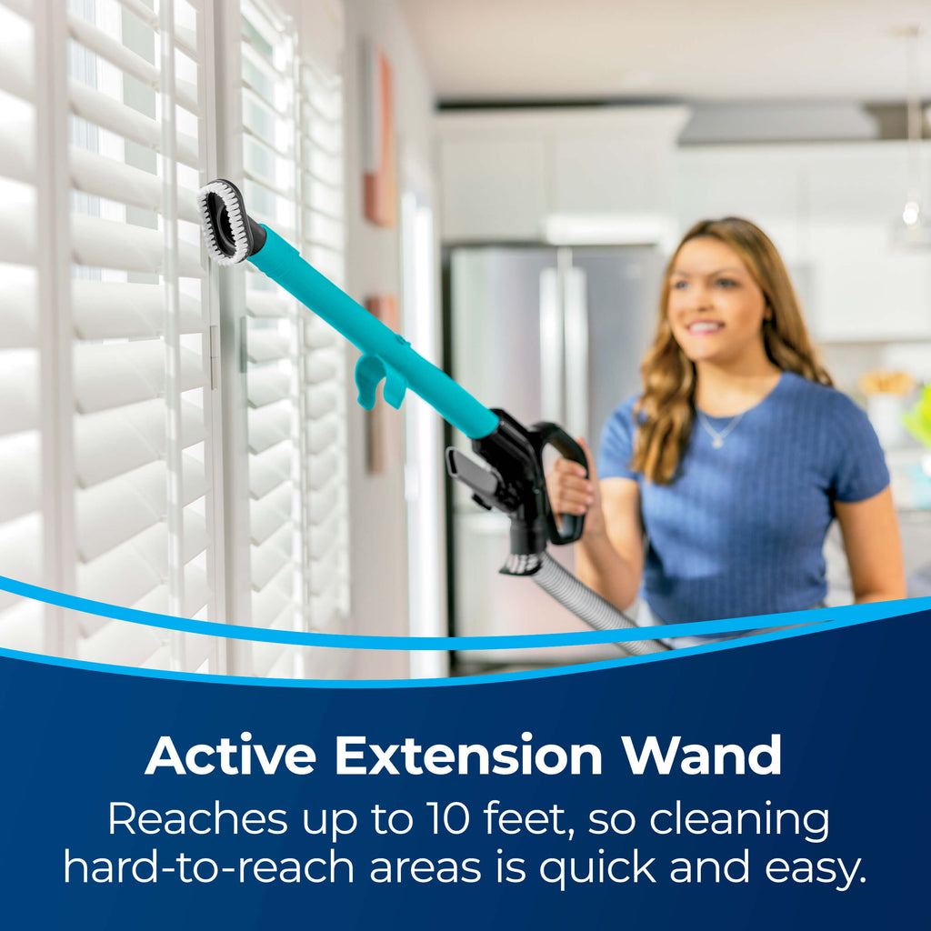 Using Extension wand to vacuum blinds. Text: Active
                        Extension Wand Reaches up to 10 feet, so cleaning hard-to-reach areas is
                        quick and easy