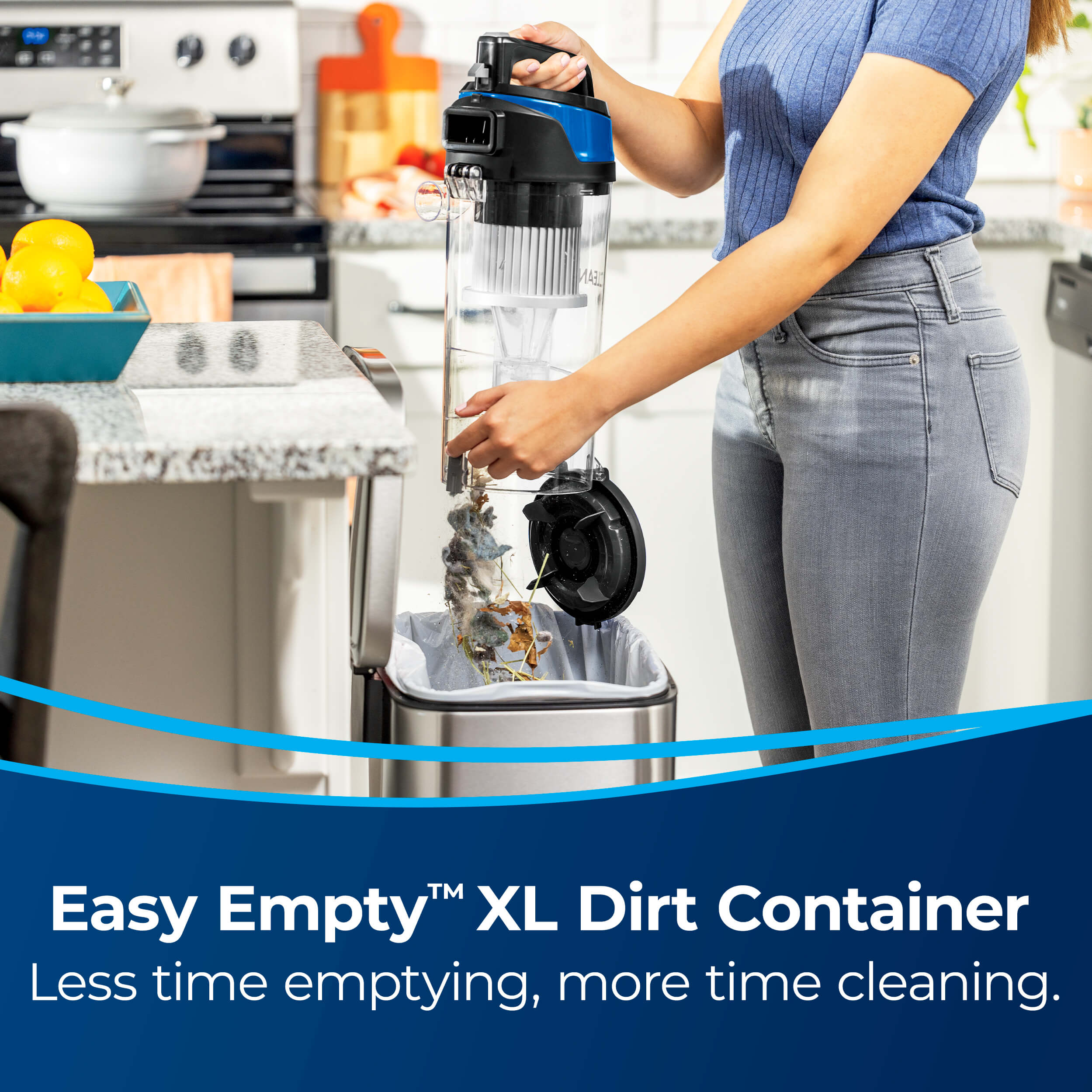 Emptying Dirt Bin in trash. Text: Easy Empty XL Dirt
                        Container. Less Time emptying, more time cleaning