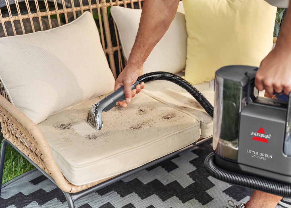 Using Little Green Cordless SmartMix Portable Cleaner to clean couch cushion