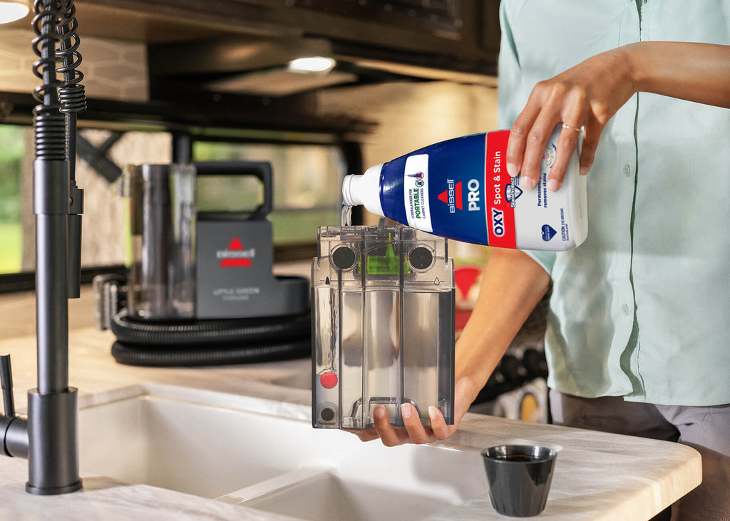 Filling solution tank with solution at kitchen sink