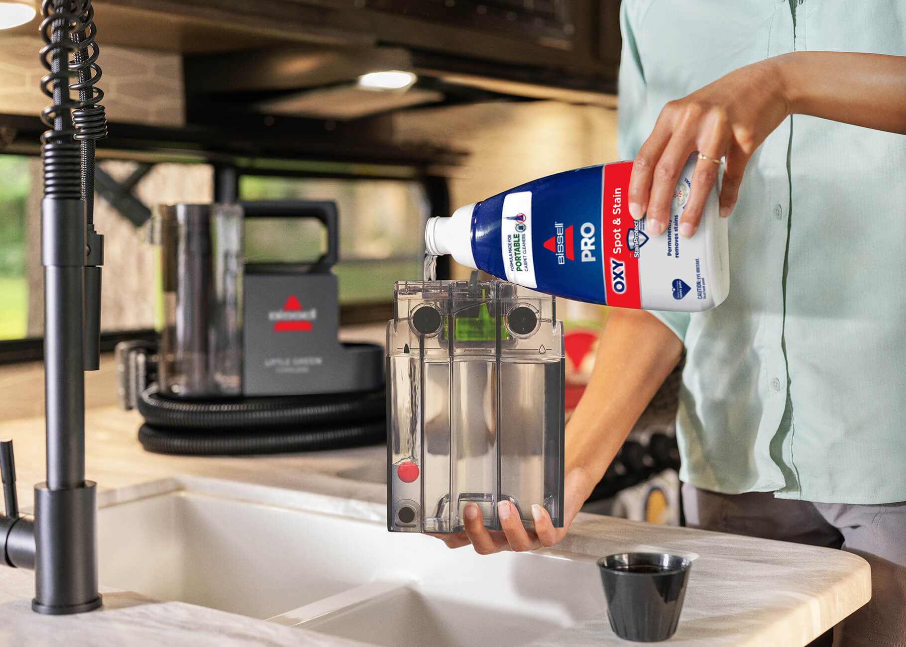 Filling solution tank with solution at kitchen sink