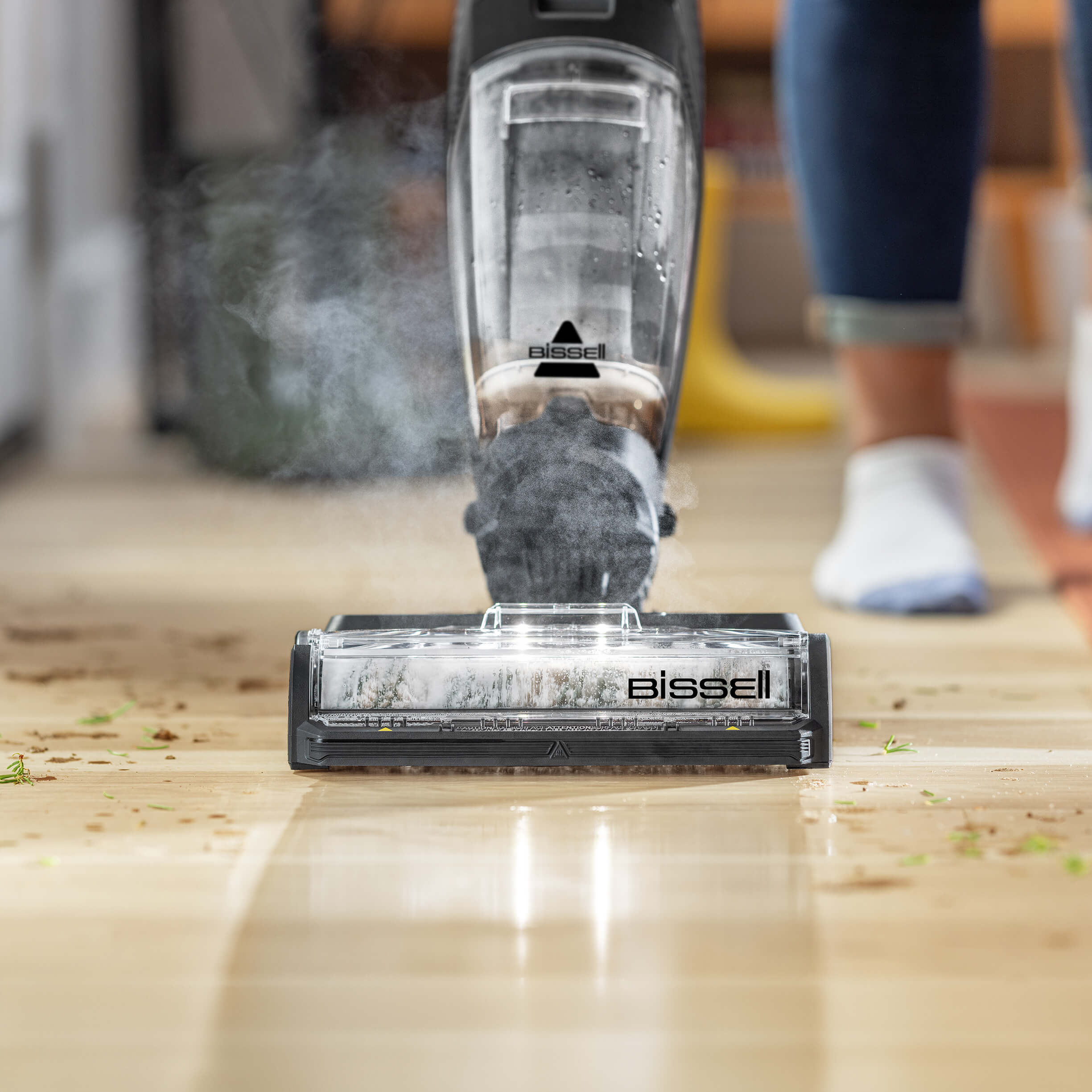 CrossWave HydroSteam vacuuming and mopping dirt from
                        hard flooring