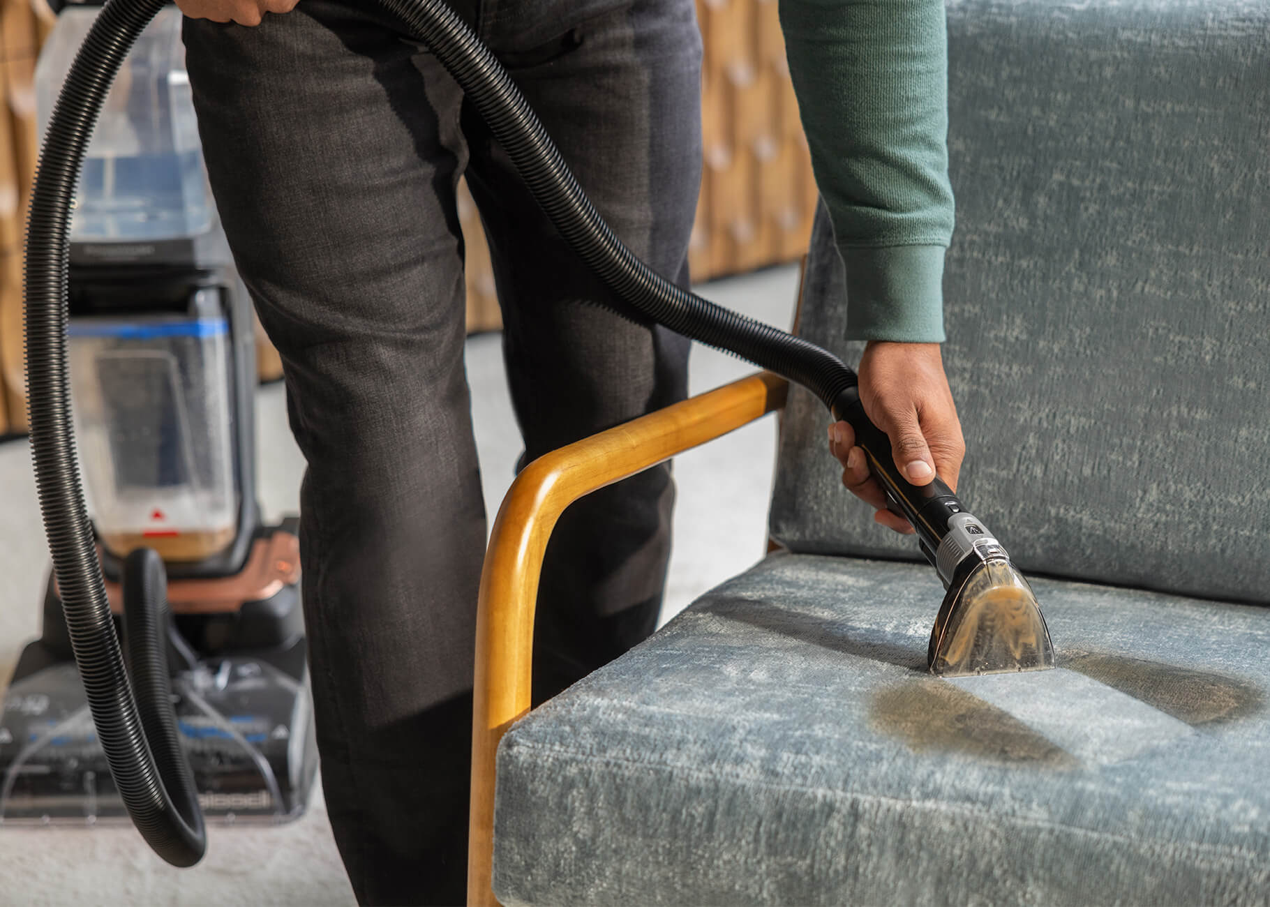 Revolution HydroSteam using upholstery tool to deep clean spill on chair cushion