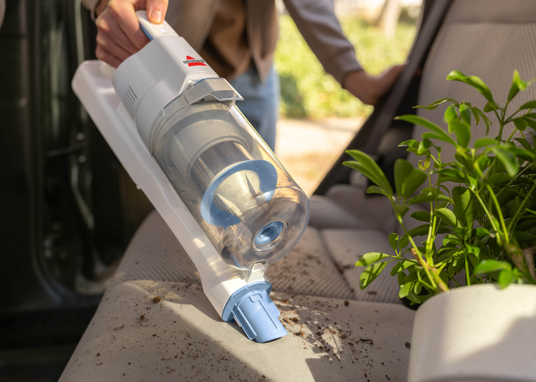 Hand vac cleaning car seat