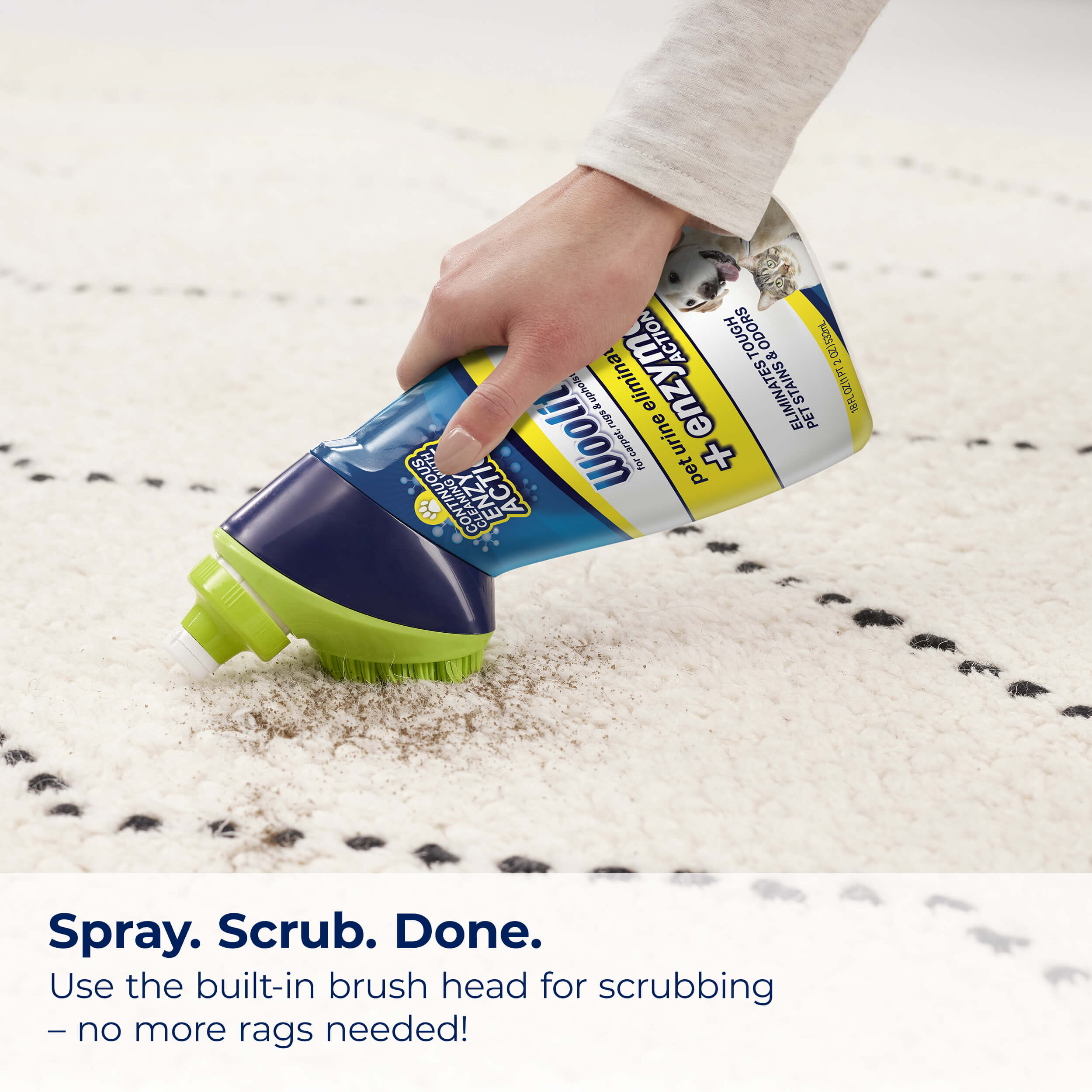 Scrubbing stain on carpet with Woolite Pet Urine
                        Eliminator. Text: Spray. Scrub. Done. Use the built-in brush head for
                        scrubbing, no more rags needed.