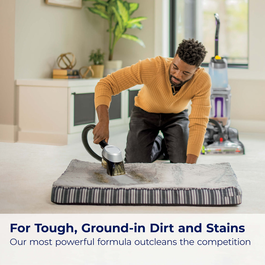 Using hose of upright carpet cleaner to clean pet bed.
                        Text: For Tough, Ground-in Dirt and Stains Our most powerful formula
                        outcleans the competition