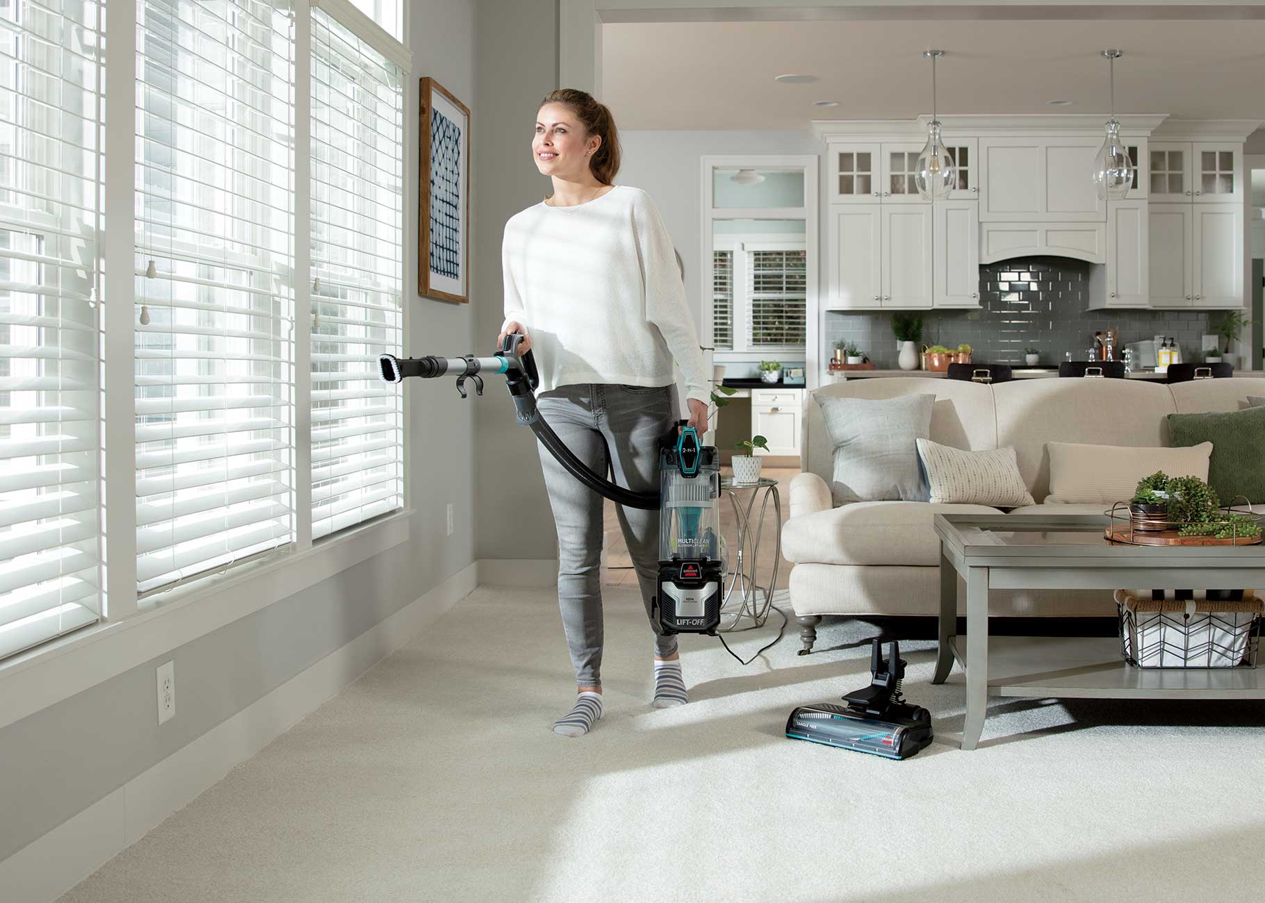 MultiClean Allergen Lift Off Pet Vacuum Cleaner vacuuming with lift off pod above floors