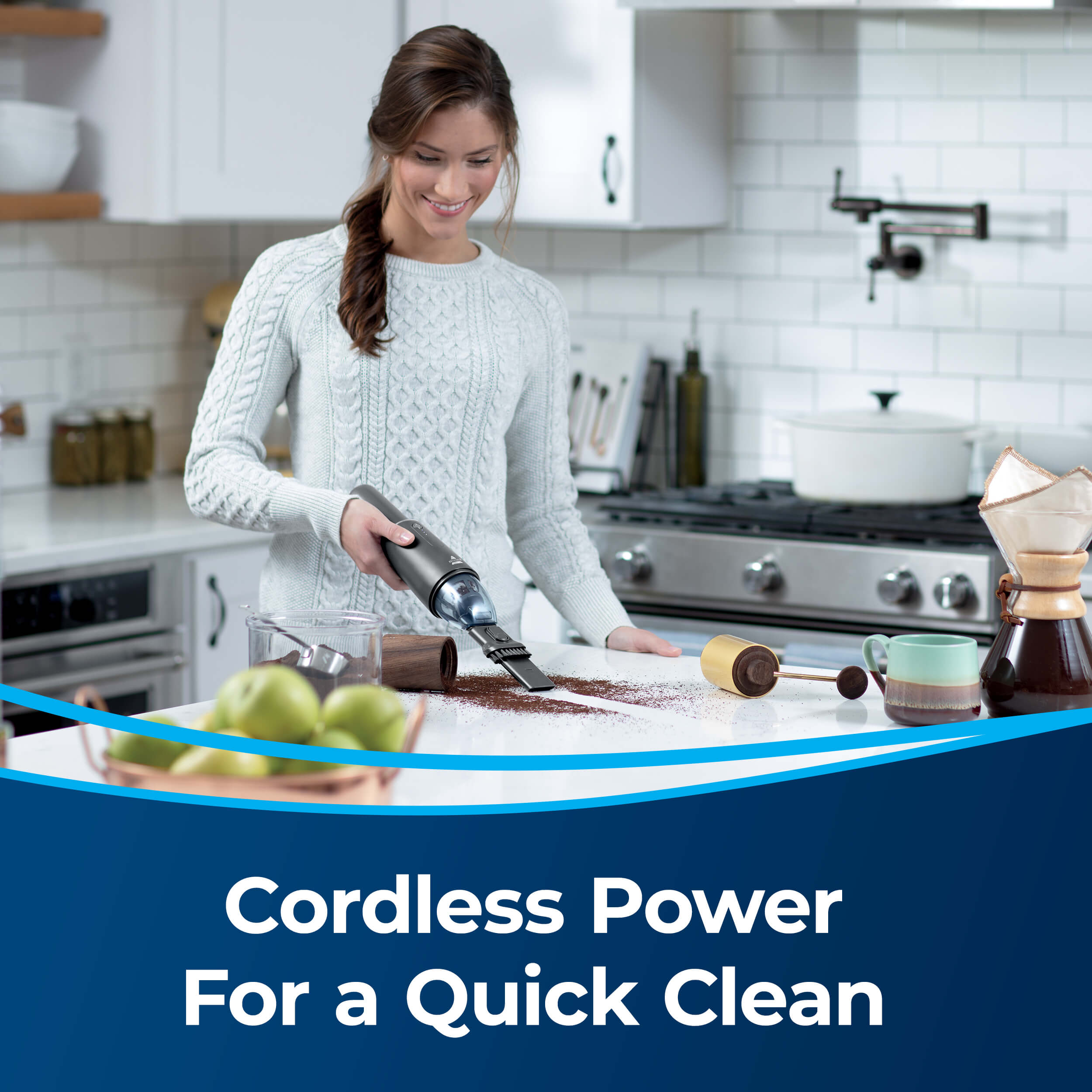 Woman Using AeroSlim Handheld Vacuum to Clean Spill on
                        Kitchen Counter. Text: Cordless Power For a Quick Clean