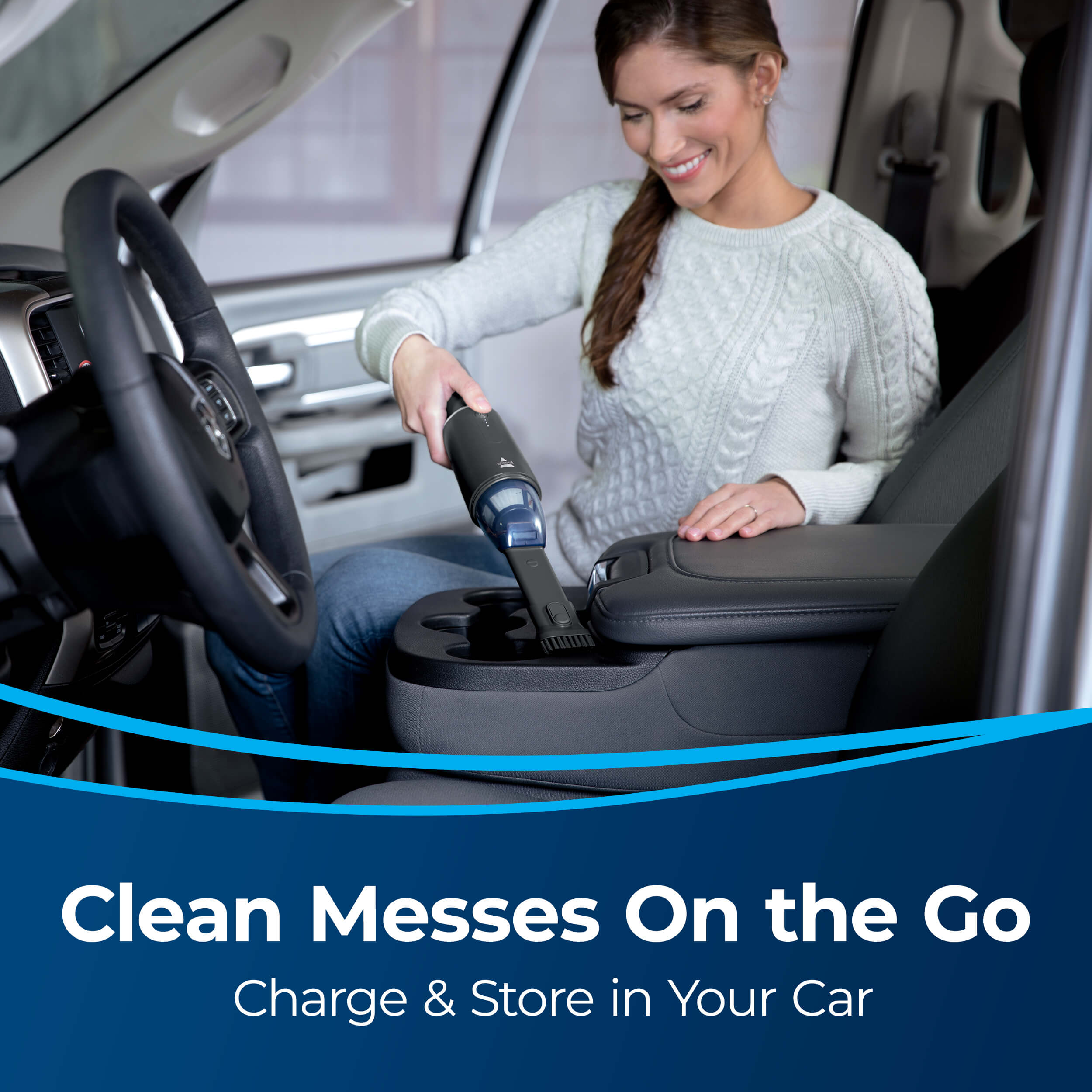 Woman Using AeroSlim Handheld Vacuum To Clean Up Cup
                        Holder in Vehicle. Text: Clean Messes On the Go, Charge & Store in Your
                        Car