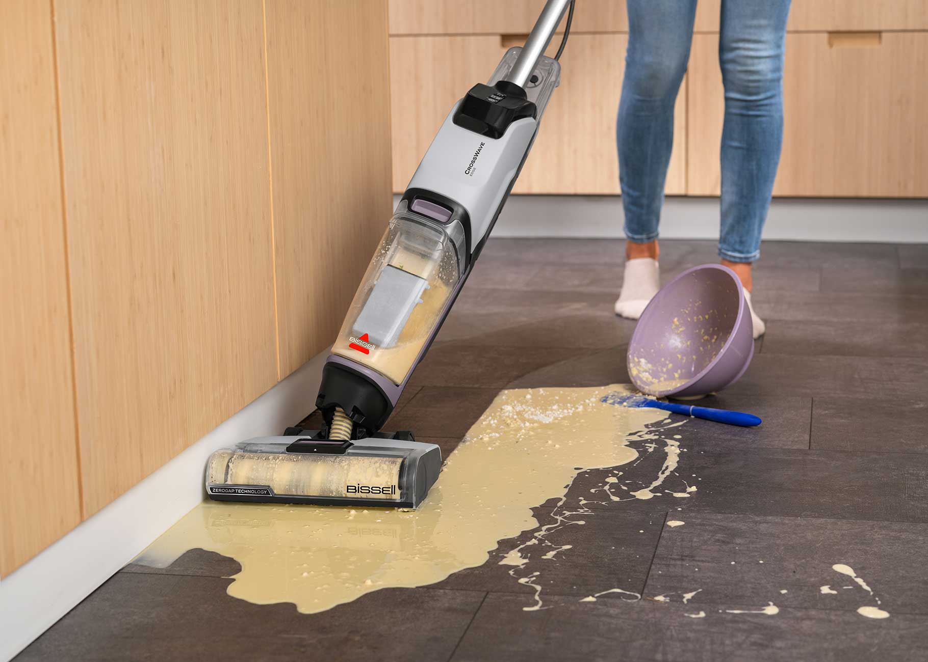 Mopping spilled mess on tile flooring along the edge