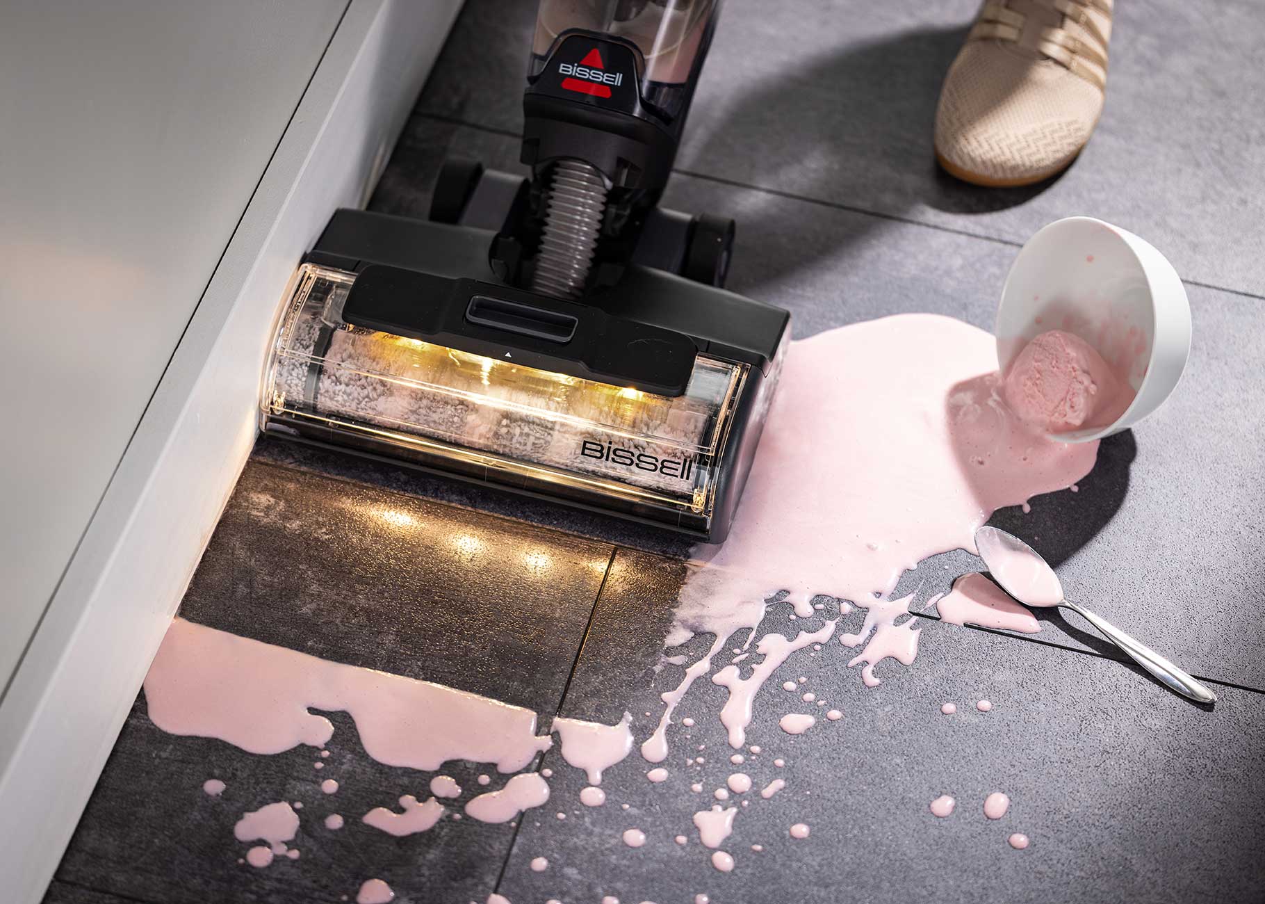 vacuuming and mopping spilled ice cream on tile flooring