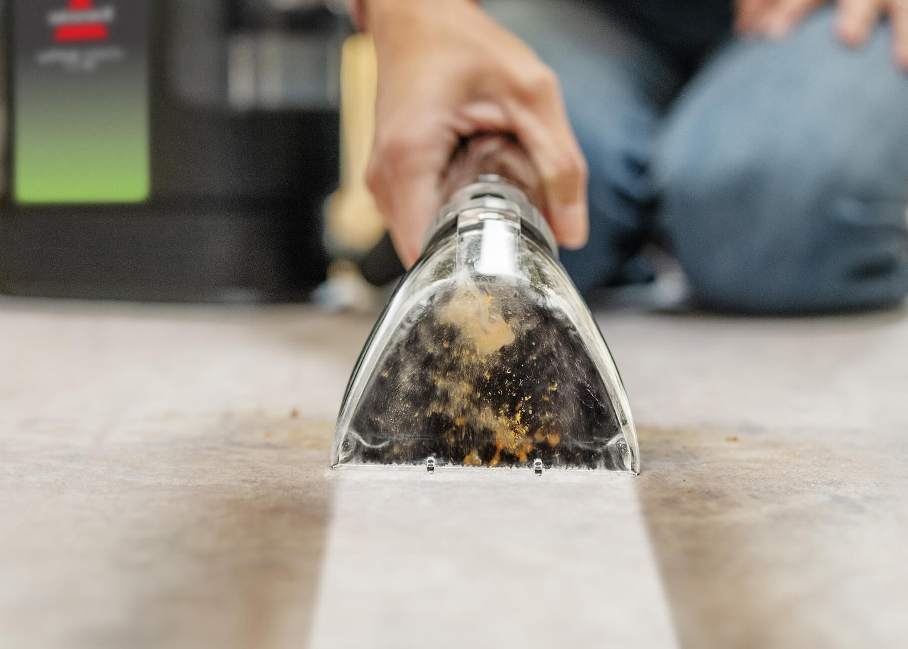 Using tool to deep clean heavy stain on carpet