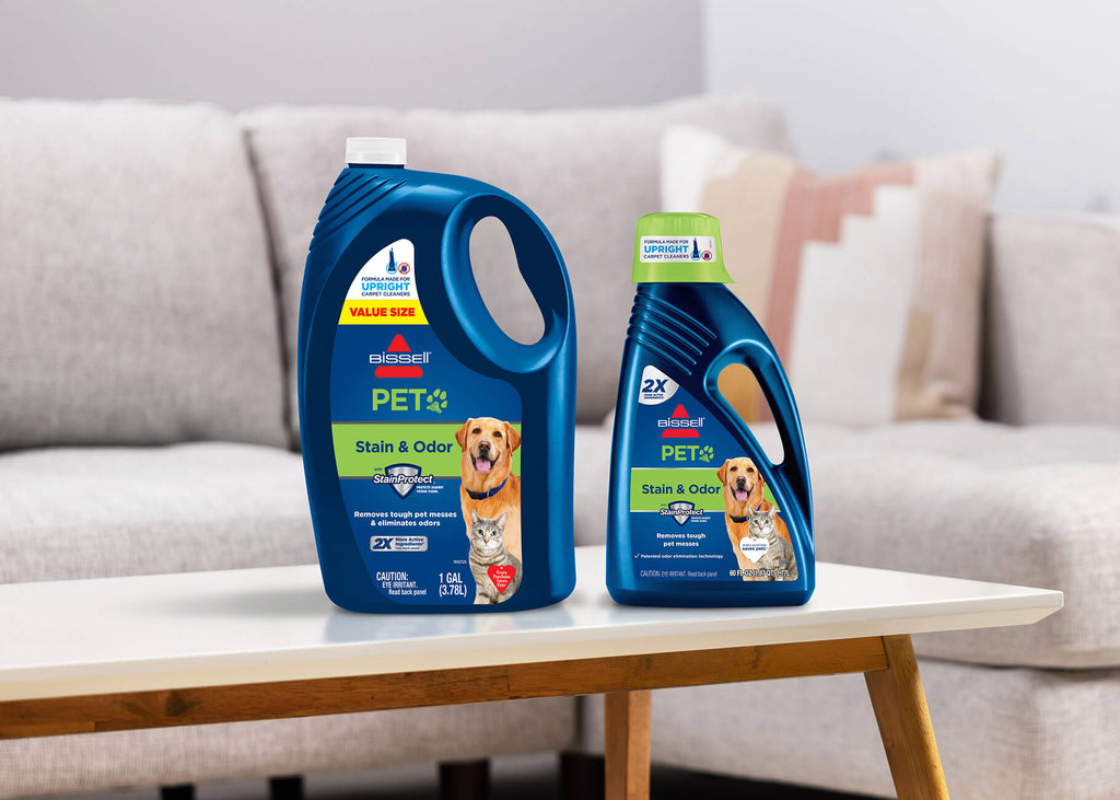 Different size bottles of formula on table